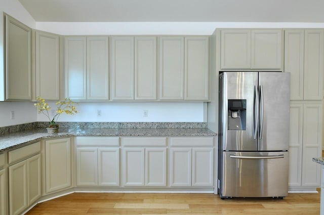2019 Chalmers Dr, Ann Arbor, MI 48104 - kitchen featuring stainless steel fridge with ice dispenser, light stone counters, and light wood finished floors