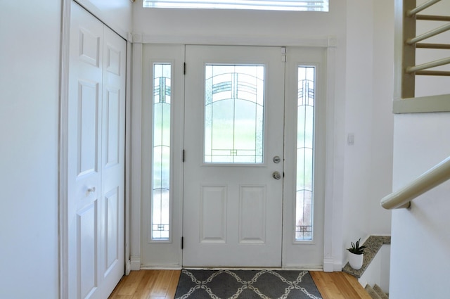 2019 Chalmers Dr, Ann Arbor, MI 48104 - foyer entrance featuring stairs, plenty of natural light, and light wood-style floors