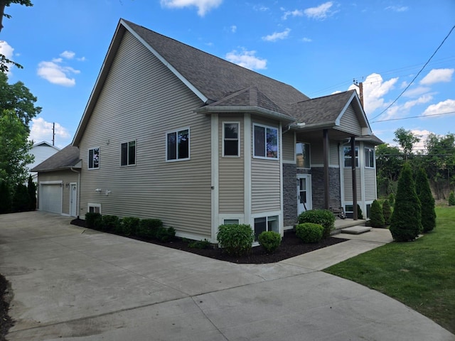 2019 Chalmers Dr, Ann Arbor, MI 48104 - view of side of home featuring roof with shingles and driveway
