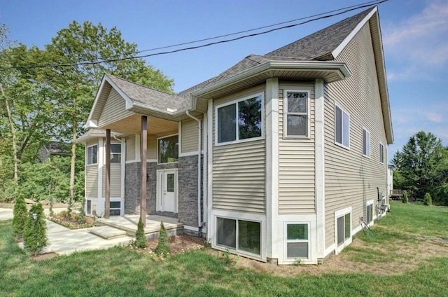 2019 Chalmers Dr, Ann Arbor, MI 48104 - view of home's exterior featuring a lawn and a shingled roof