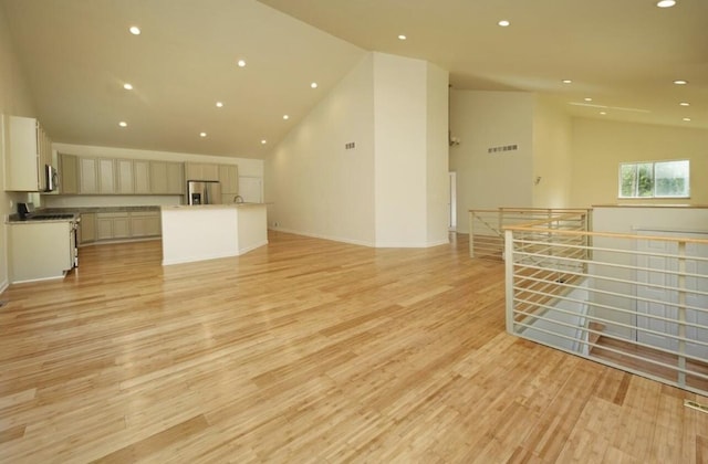2019 Chalmers Dr, Ann Arbor, MI 48104 - unfurnished living room featuring light wood-type flooring, recessed lighting, and high vaulted ceiling