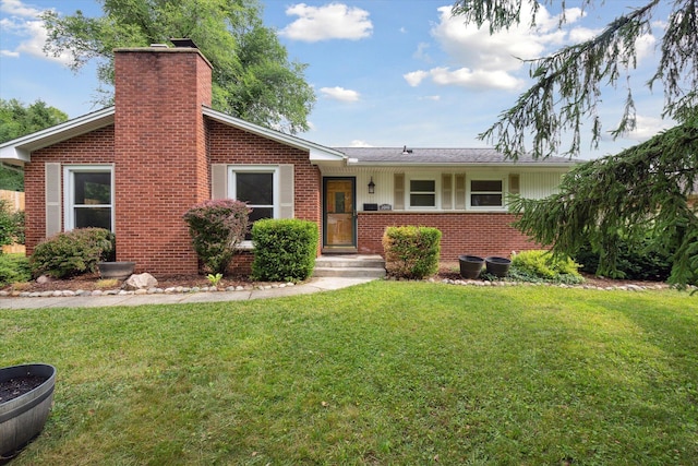 2010 Brampton Ct, Ann Arbor, MI 48103 - view of front of house featuring brick siding, a chimney, and a front yard