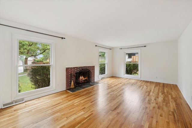 2010 Brampton Ct, Ann Arbor, MI 48103 - unfurnished living room with wood finished floors and a brick fireplace