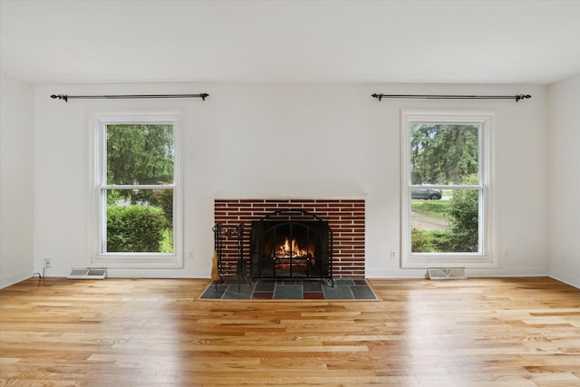 2010 Brampton Ct, Ann Arbor, MI 48103 - unfurnished living room with wood finished floors and a fireplace with flush hearth