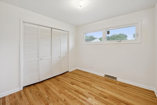 2010 Brampton Ct, Ann Arbor, MI 48103 - unfurnished bedroom with light wood-type flooring and a closet