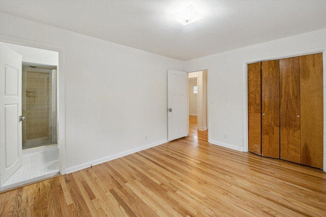 2010 Brampton Ct, Ann Arbor, MI 48103 - unfurnished bedroom with light wood-type flooring, a closet, and ensuite bathroom