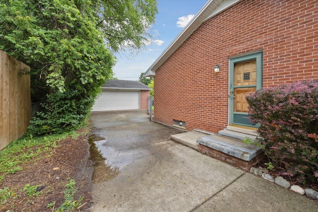 2010 Brampton Ct, Ann Arbor, MI 48103 - view of property exterior featuring entry steps, an outdoor structure, brick siding, and a detached garage