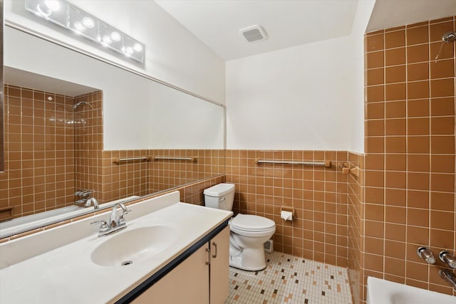 2010 Brampton Ct, Ann Arbor, MI 48103 - full bathroom featuring tile walls, vanity, tile patterned flooring,  shower combination, and wainscoting