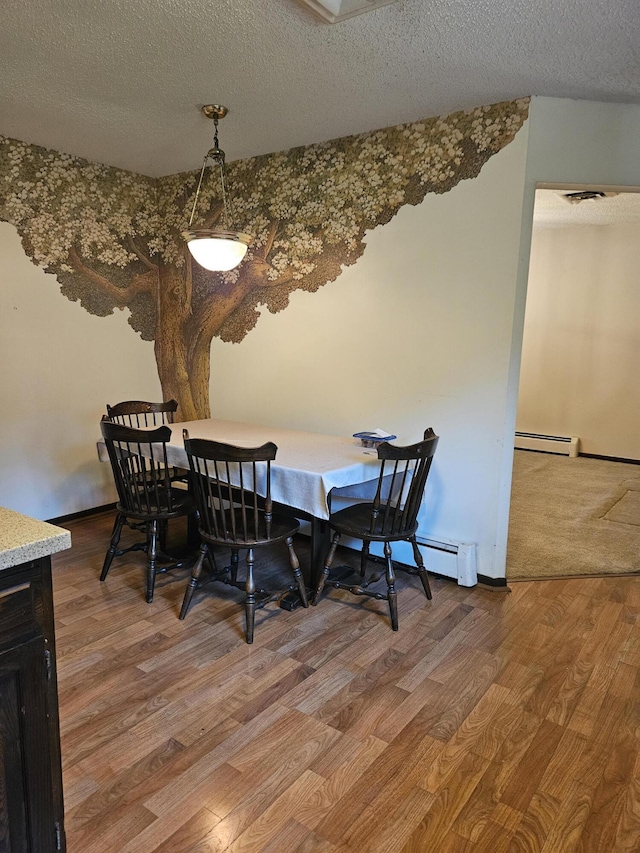 4810 Grandview Dr, Ypsilanti, MI 48197 - dining space with a baseboard radiator, a textured ceiling, and wood finished floors