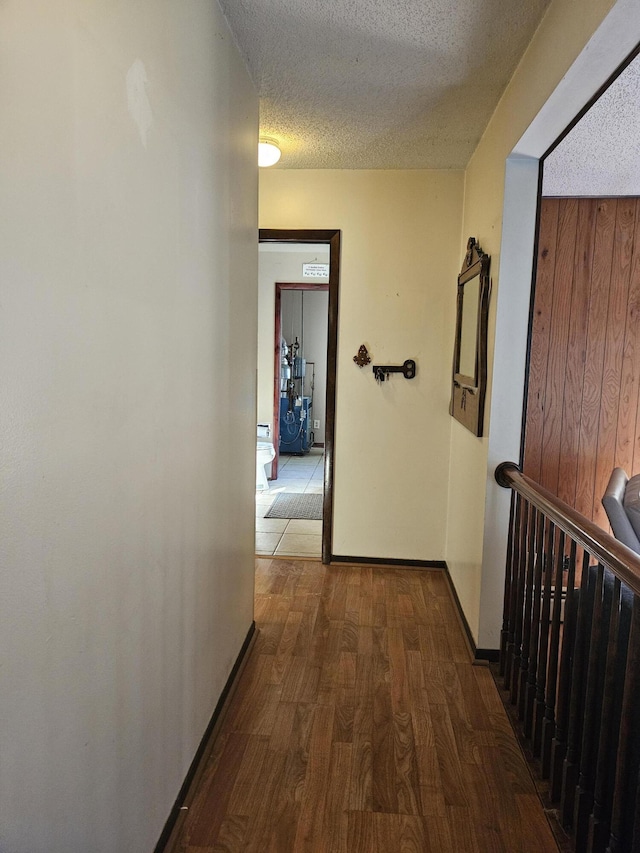 4810 Grandview Dr, Ypsilanti, MI 48197 - corridor featuring a textured ceiling, wood finished floors, and wooden walls