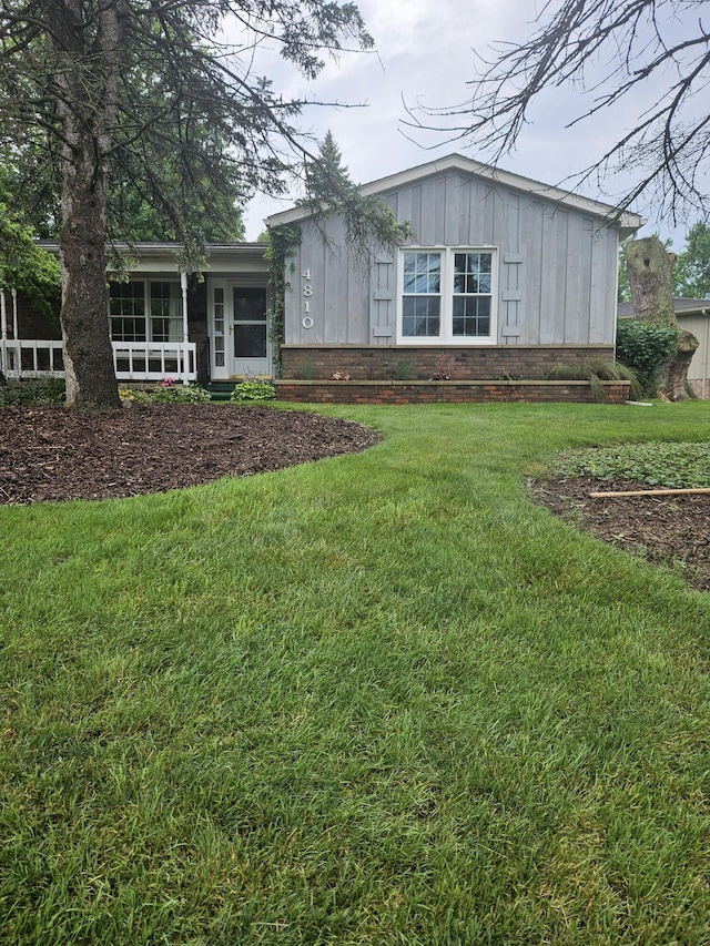 4810 Grandview Dr, Ypsilanti, MI 48197 - view of front of property featuring board and batten siding and a front lawn