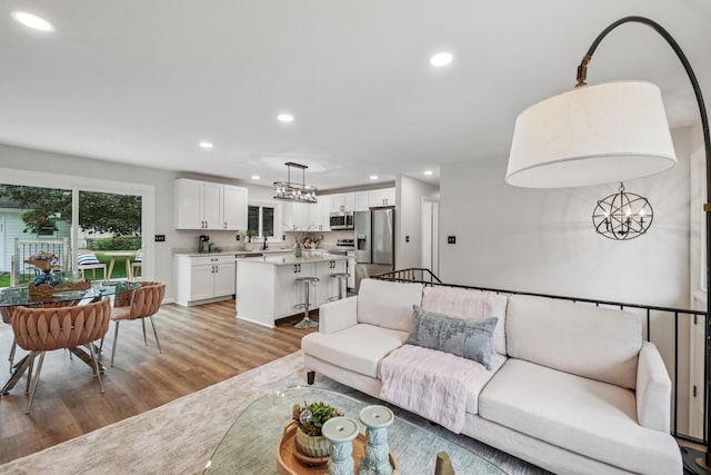 3110 Hilltop Dr, Ann Arbor, MI 48103 - living area featuring a chandelier, light wood finished floors, and recessed lighting