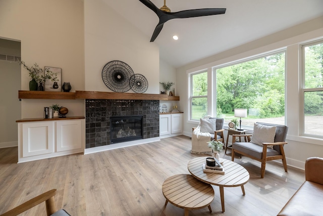 1717 Toscana St, Kalamazoo, MI 49009 - living room featuring light wood-style floors, a fireplace, ceiling fan, vaulted ceiling, and recessed lighting