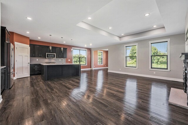 8275 Woodhaven Dr SW, Byron Center, MI 49315 - kitchen with appliances with stainless steel finishes, open floor plan, dark wood-style floors, light countertops, and recessed lighting