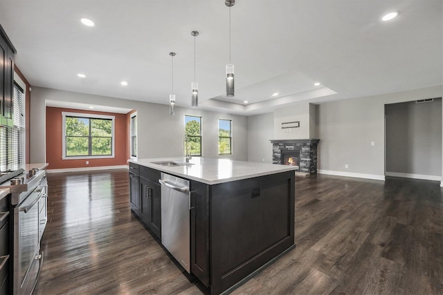 8275 Woodhaven Dr SW, Byron Center, MI 49315 - kitchen with dishwasher, open floor plan, light countertops, plenty of natural light, and recessed lighting