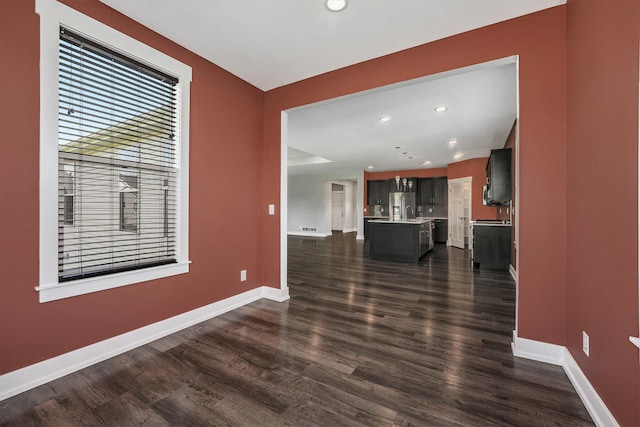 8275 Woodhaven Dr SW, Byron Center, MI 49315 - unfurnished living room featuring dark wood-type flooring and recessed lighting