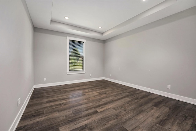 8275 Woodhaven Dr SW, Byron Center, MI 49315 - empty room featuring recessed lighting, a raised ceiling, and dark wood-style flooring