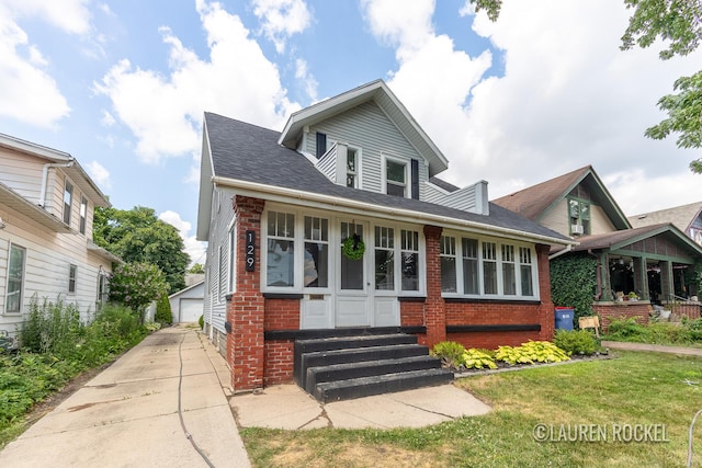 129 Dean St NE, Grand Rapids, MI 49505 - view of front of property with entry steps, brick siding, an outdoor structure, a detached garage, and a front yard