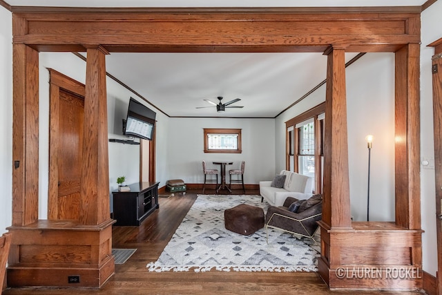 129 Dean St NE, Grand Rapids, MI 49505 - living area with dark wood-style flooring, a ceiling fan, ornamental molding, and ornate columns