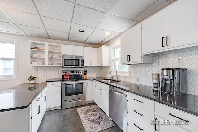 129 Dean St NE, Grand Rapids, MI 49505 - kitchen with stainless steel appliances, a drop ceiling, backsplash, white cabinets, and recessed lighting