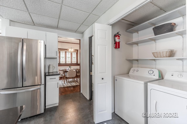 129 Dean St NE, Grand Rapids, MI 49505 - laundry area with washer and dryer, a chandelier, and dark floors