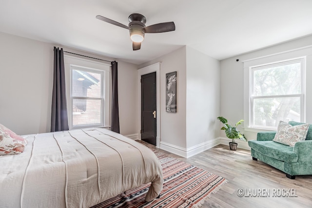 129 Dean St NE, Grand Rapids, MI 49505 - bedroom with multiple windows, wood finished floors, and a ceiling fan