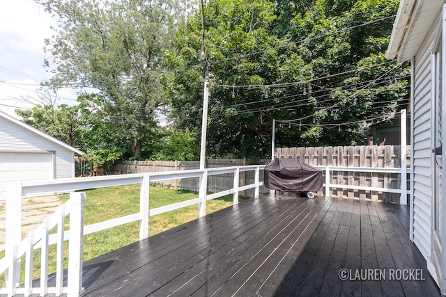 129 Dean St NE, Grand Rapids, MI 49505 - wooden terrace with a fenced backyard, area for grilling, and an outbuilding