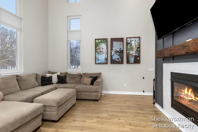 1932 Buehler Rd, Hastings, MI 49058 - living room with a high ceiling, light wood-style floors, and a fireplace