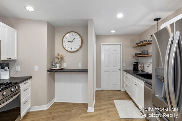 1932 Buehler Rd, Hastings, MI 49058 - kitchen with appliances with stainless steel finishes, dark countertops, open shelves, light wood-style floors, and recessed lighting