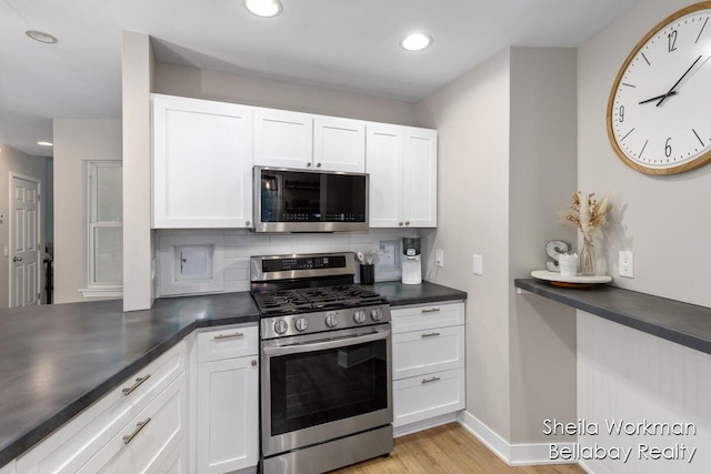 1932 Buehler Rd, Hastings, MI 49058 - kitchen with stainless steel appliances, dark countertops, tasteful backsplash, white cabinetry, and recessed lighting
