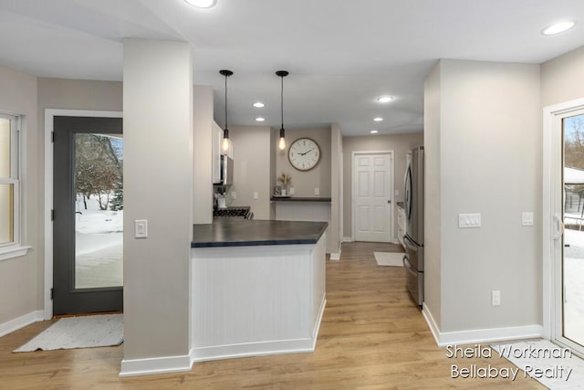 1932 Buehler Rd, Hastings, MI 49058 - kitchen featuring dark countertops, light wood-style floors, recessed lighting, decorative light fixtures, and stainless steel appliances