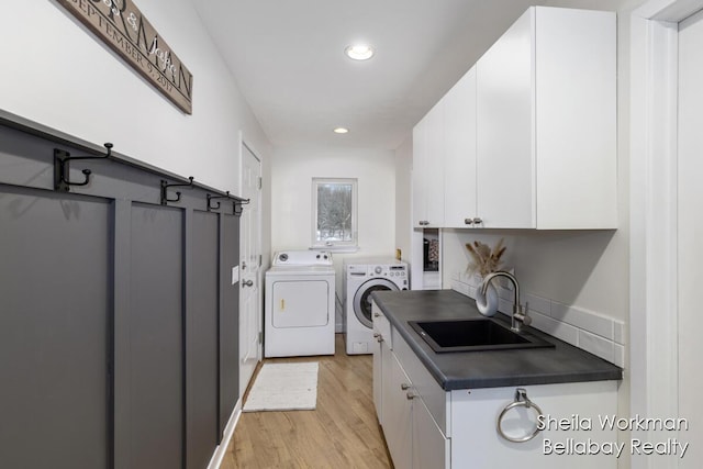 1932 Buehler Rd, Hastings, MI 49058 - washroom with independent washer and dryer, light wood-style floors, recessed lighting, and cabinet space