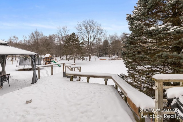 1932 Buehler Rd, Hastings, MI 49058 - snowy yard featuring a playground, a trampoline, and a gazebo