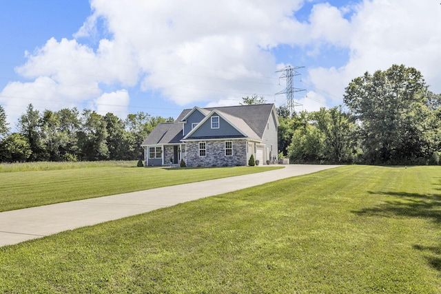 9430 Island Lake Rd, Dexter, MI 48130 - view of front of property with stone siding, a front lawn, driveway, and a garage