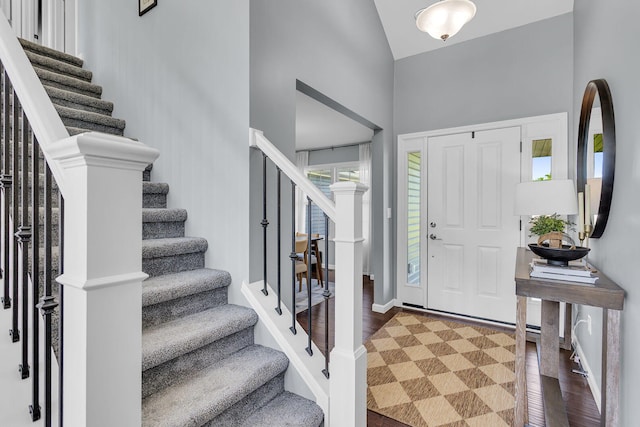 9430 Island Lake Rd, Dexter, MI 48130 - entryway with high vaulted ceiling, stairs, and wood finished floors