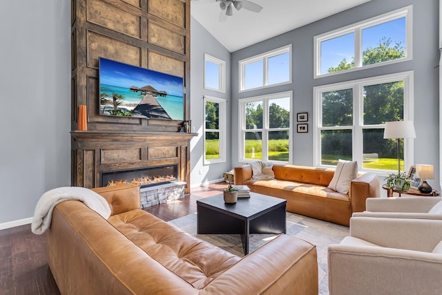 9430 Island Lake Rd, Dexter, MI 48130 - living room featuring wood finished floors, high vaulted ceiling, a ceiling fan, and a large fireplace