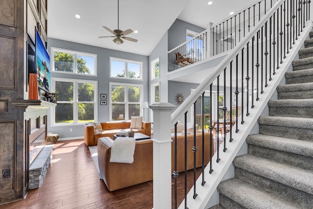 9430 Island Lake Rd, Dexter, MI 48130 - living area featuring hardwood / wood-style floors, a ceiling fan, healthy amount of natural light, stairway, and high vaulted ceiling