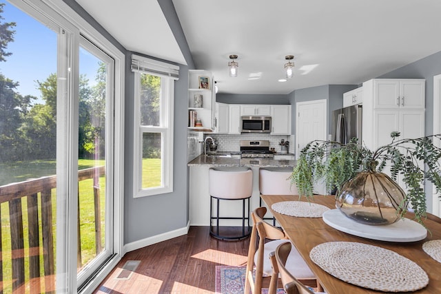 9430 Island Lake Rd, Dexter, MI 48130 - dining area with dark wood-style flooring and baseboards