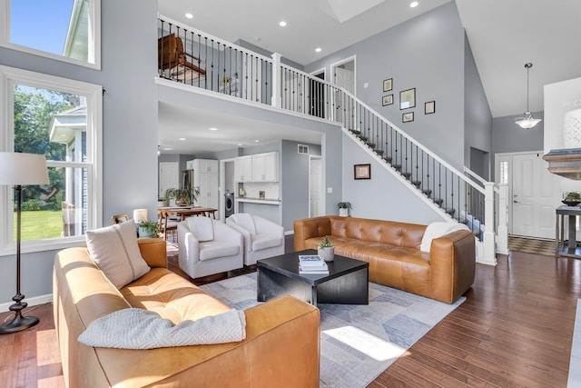 9430 Island Lake Rd, Dexter, MI 48130 - living room with a towering ceiling, healthy amount of natural light, wood finished floors, stairs, and recessed lighting