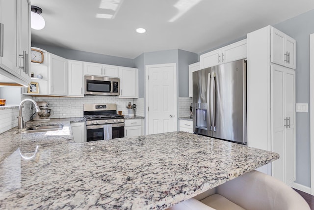 9430 Island Lake Rd, Dexter, MI 48130 - kitchen featuring stainless steel appliances, open shelves, light stone countertops, a peninsula, and white cabinets