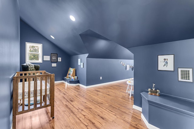 9430 Island Lake Rd, Dexter, MI 48130 - bedroom featuring lofted ceiling, wood finished floors, and a crib