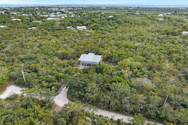 birds eye view of property with a forest view