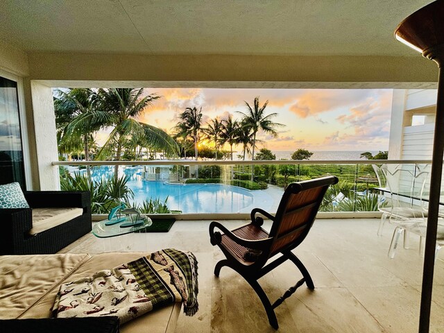 97501 Overseas Hwy Unit 521, Key Largo, FL 33037 - pool at dusk with an outdoor hangout area and a water view