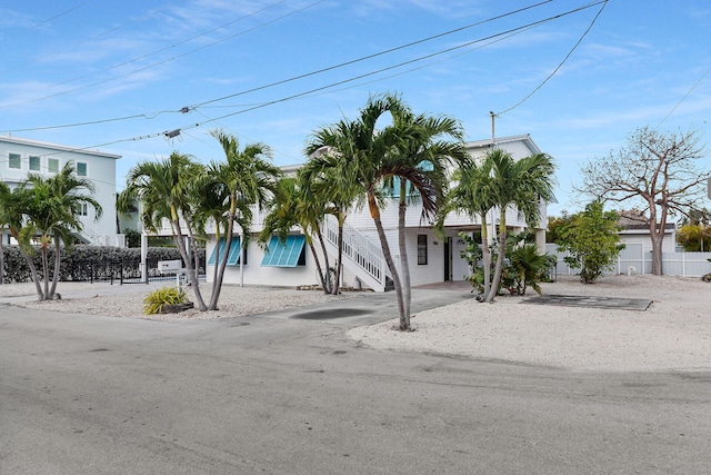 699 116th St, Ocean, Marathon, FL 33050 - coastal inspired home with a carport, stairway, driveway, and fence