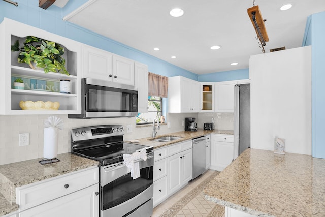 699 116th St, Ocean, Marathon, FL 33050 - kitchen featuring light stone counters, tasteful backsplash, white cabinets, a sink, and appliances with stainless steel finishes