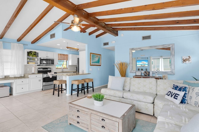 699 116th St, Ocean, Marathon, FL 33050 - living area with light tile patterned floors, visible vents, ceiling fan, and vaulted ceiling with beams