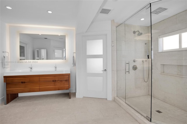 bathroom with vanity and a shower with door