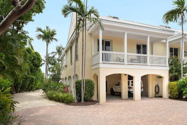 81250 Overseas Hwy Unit 1, Islamorada, FL 33036 - view of home's exterior with a carport, stucco siding, and decorative driveway