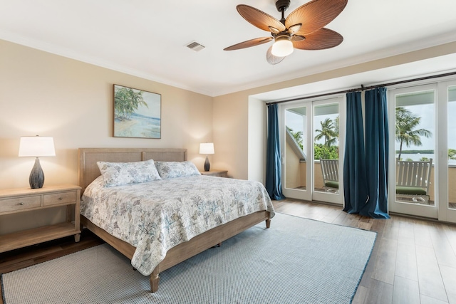 81250 Overseas Hwy Unit 1, Islamorada, FL 33036 - bedroom with crown molding, access to exterior, wood finished floors, and a ceiling fan