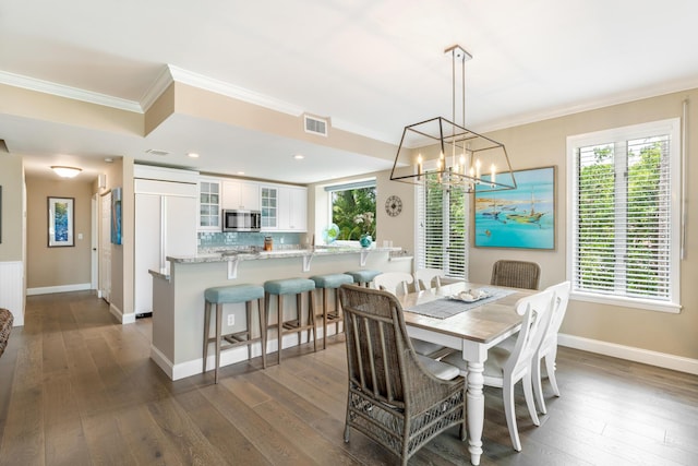 81250 Overseas Hwy Unit 1, Islamorada, FL 33036 - dining space with dark wood-type flooring, ornamental molding, a chandelier, and recessed lighting